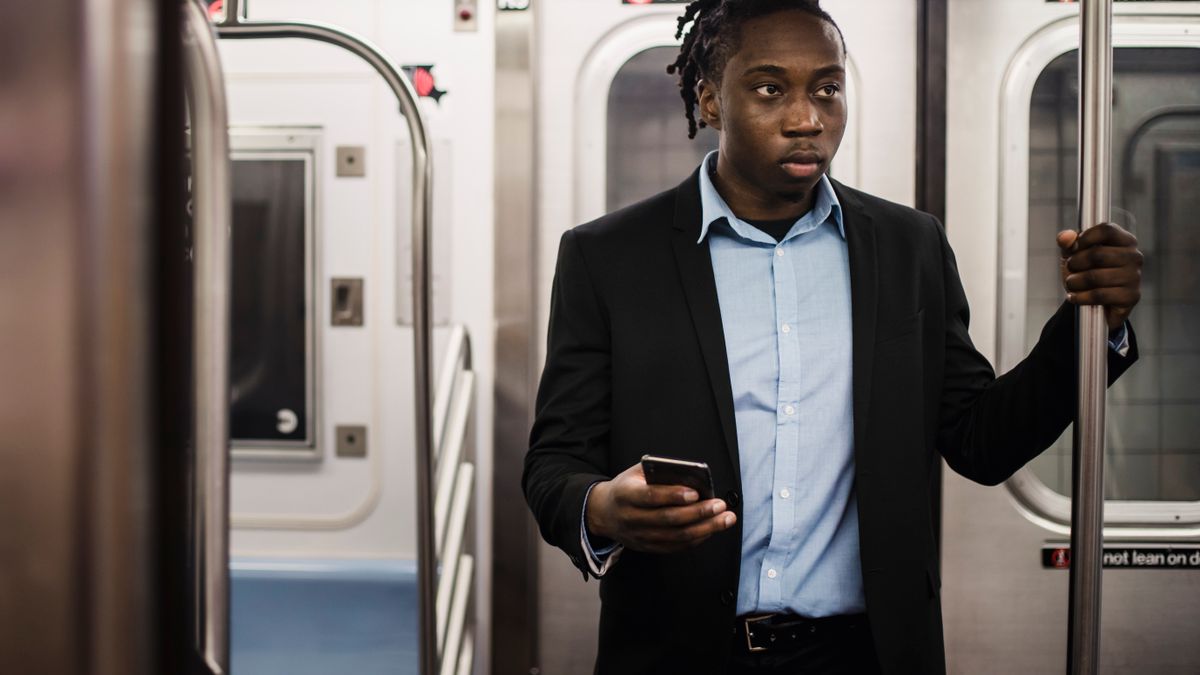 Phone in hand on a train